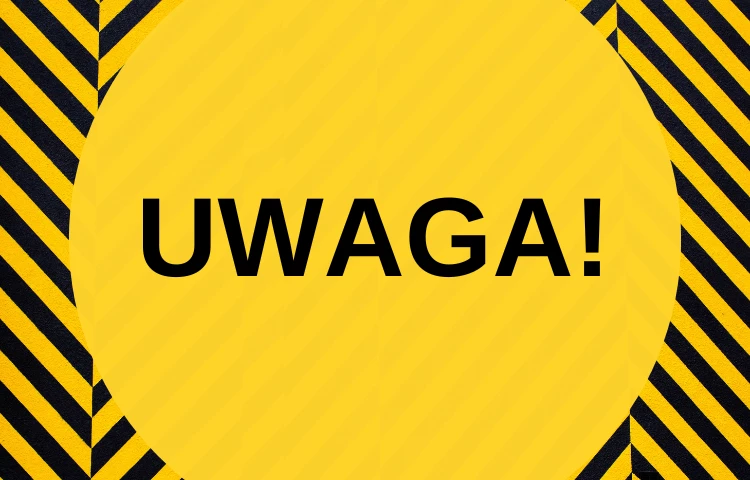 Żółto czarna plansza z napisem uwaga